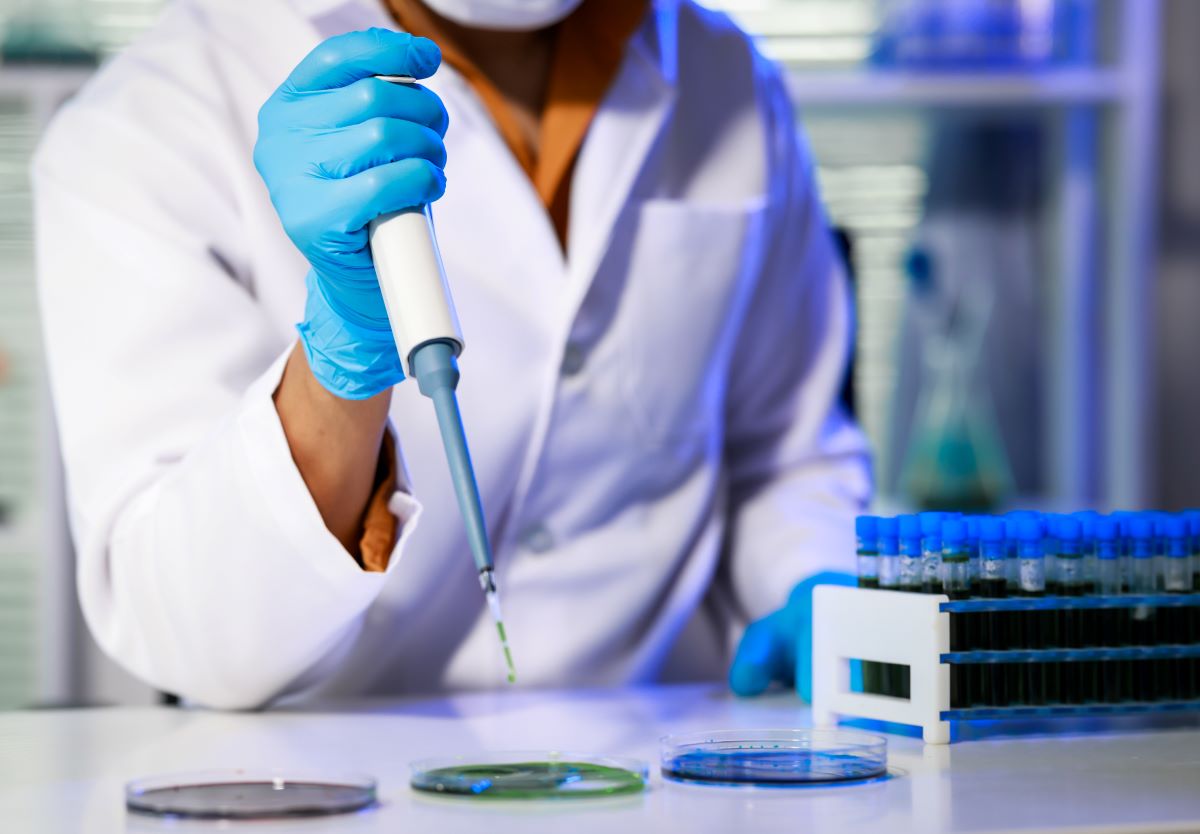 Lab technician separating liquid into dishes