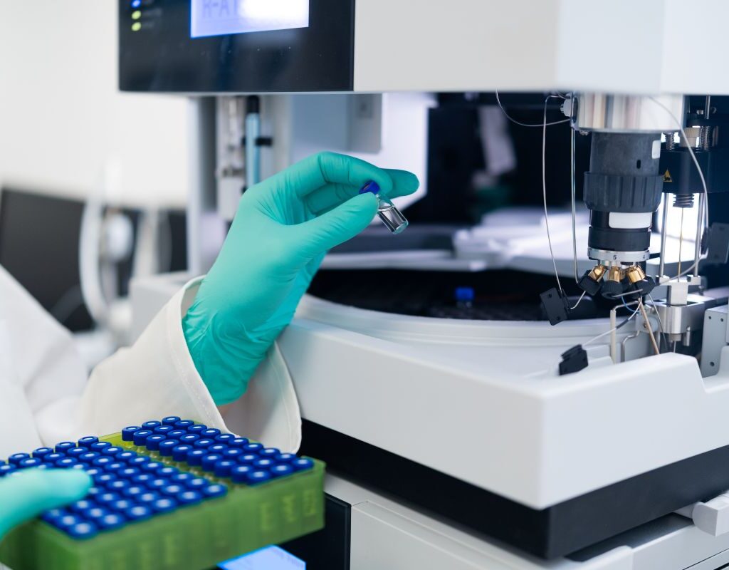Lab technician placing samples into a machine