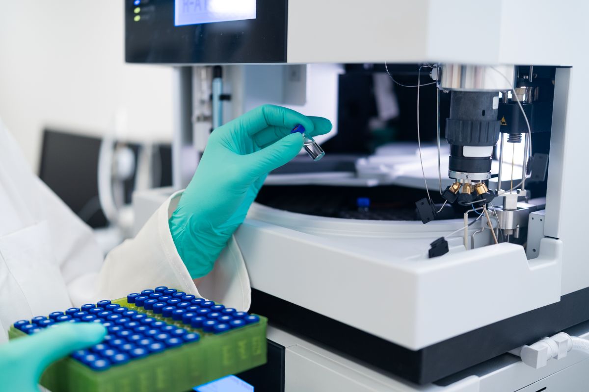 Lab technician placing samples into a machine